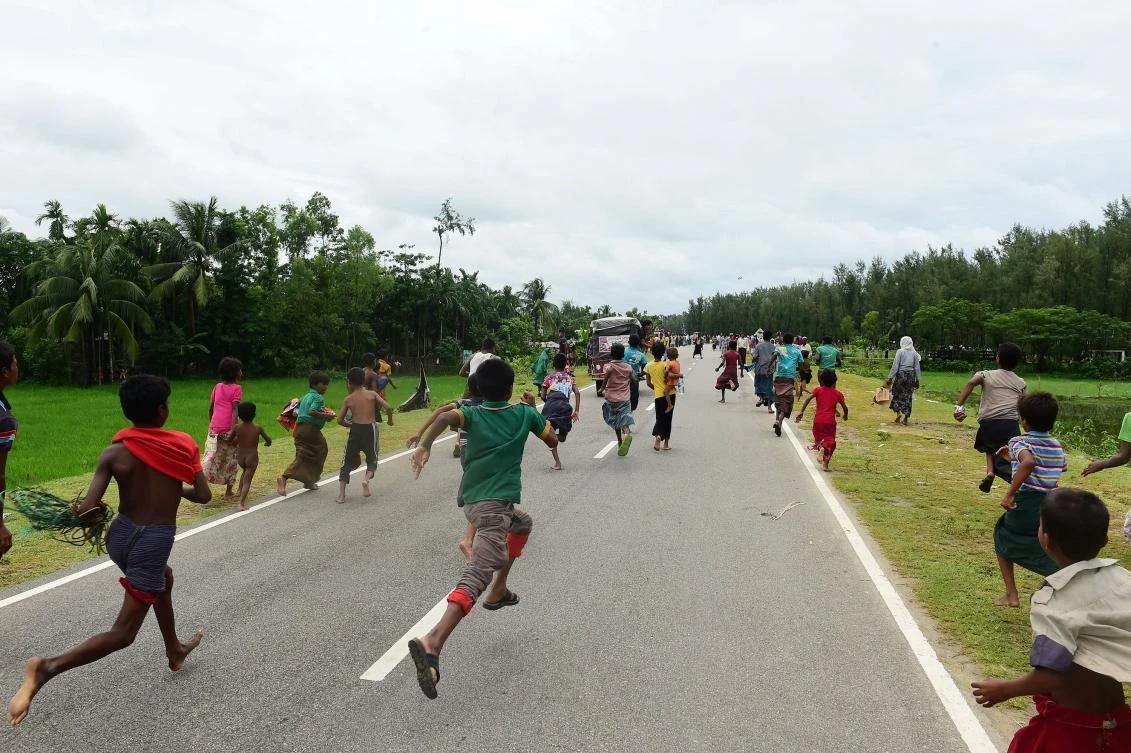 Rohingya Muslim refugees children follow a vehicle with relief supplies near the Bangladeshi town of Teknaf. (AFP)