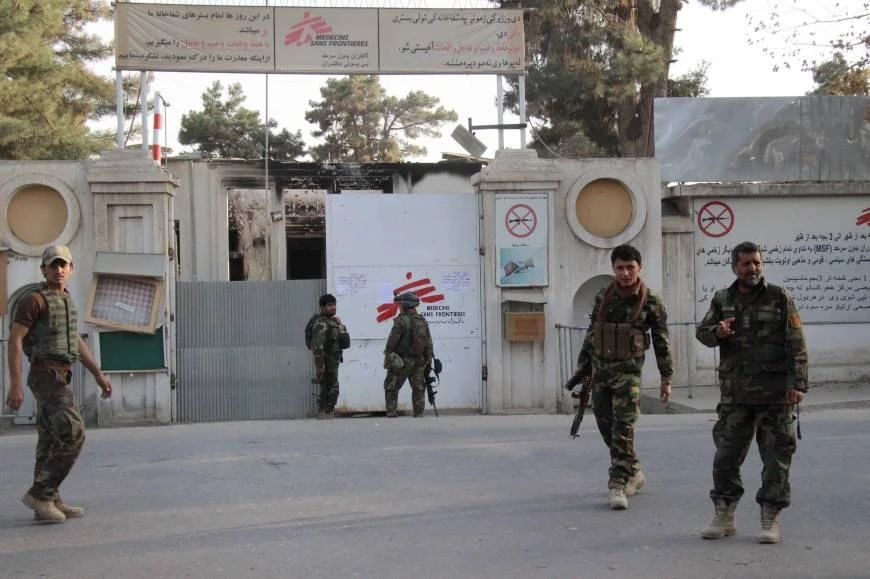 Afghan security forces walk near the entrance gate of the Medecins Sans Frontieres (MSF) hospital after retaking control of the city from Taliban insurgents, in Kunduz on Thursday. (AFP)