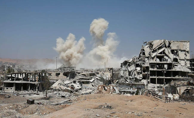 Smoke rises from buildings following a strike on an opposition-held area of the Jobar district, east of the Syrian capital on Thursday. (AFP)
