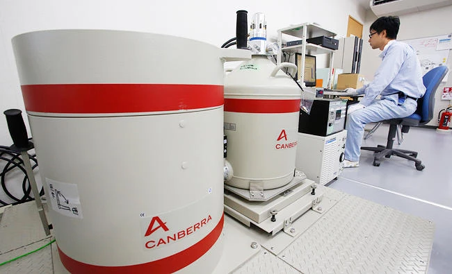 In this July 19, 2016 file photo, a worker watches a monitor of radioactivity detector at Reduction Recycling Pilot plant in Iidate, Fukushima Prefecture, northeastern Japan. (AP)