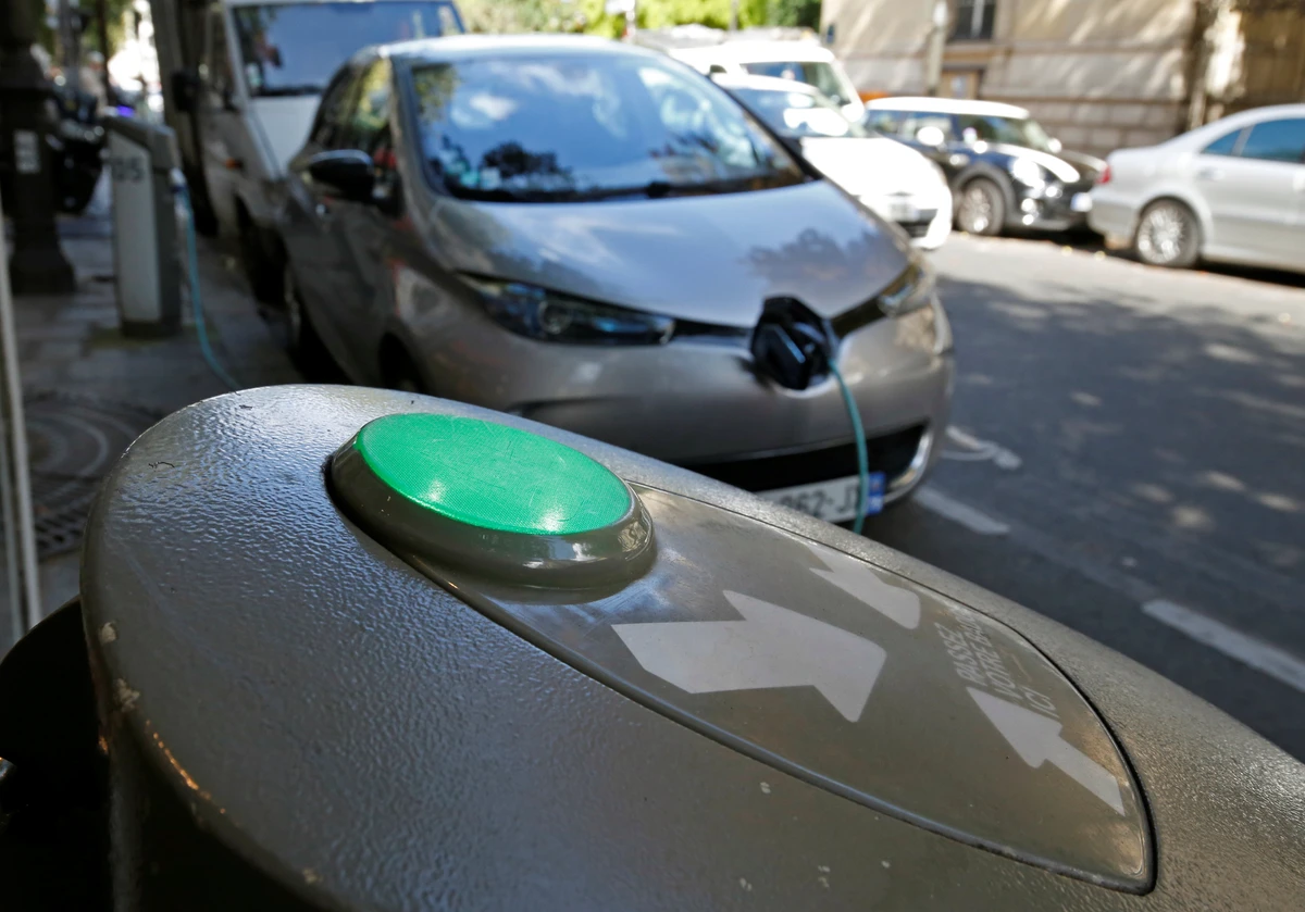 Above, an electric car is being charged in a Paris street in France. (Reuters)