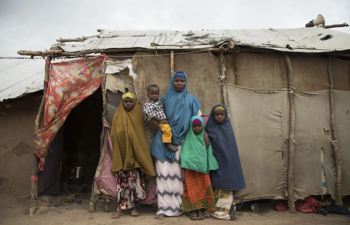 Somali refugee and mother of four Asho Manangara Ibrahim stands with her children at Kakuma Refugee Camp in northern Kenya. (Kellie Ryan/International Rescue Committee via AP)