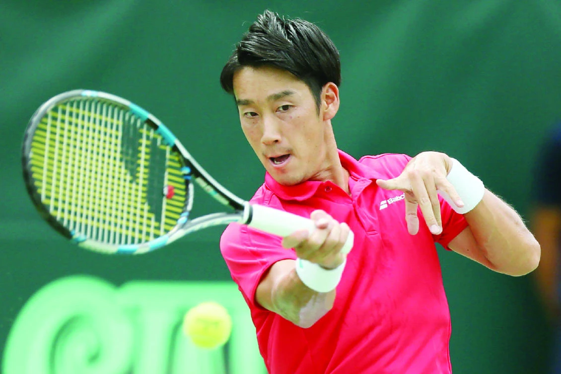 Yuichi Sugita of Japan returns the ball to Guilherme Clezar of Brazil during the first tennis match of Davis Cup World Group playoff in Osaka on Thursday. (AFP)