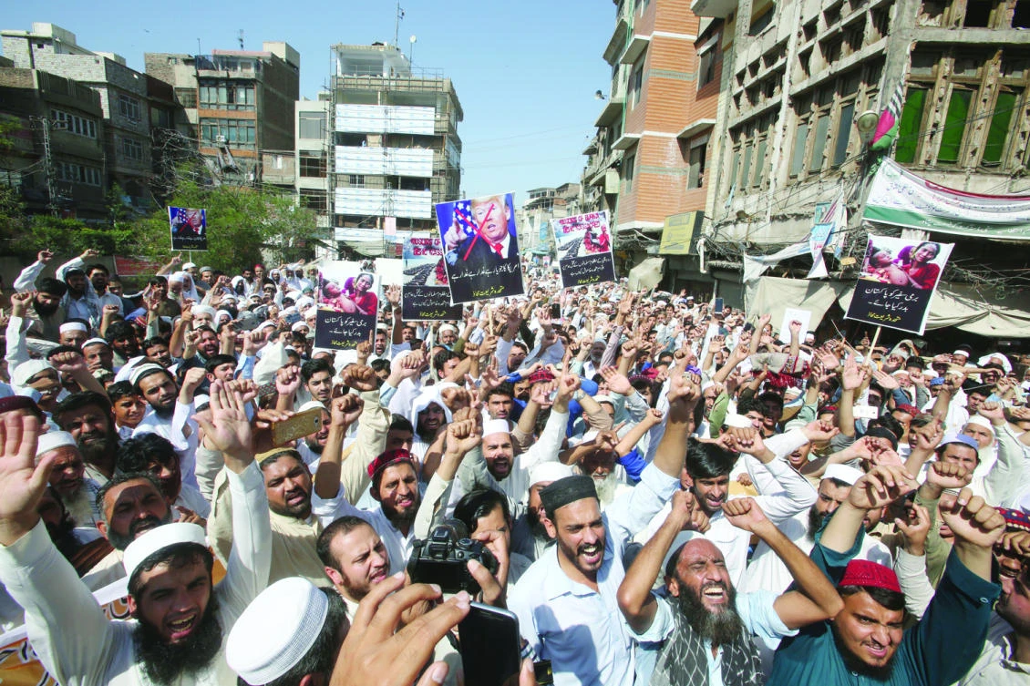 Protesters stage a rally on Friday in the Pakistani city of Peshawar to condemn ongoing violence against the Rohingya minority in Myanmar. (AP)