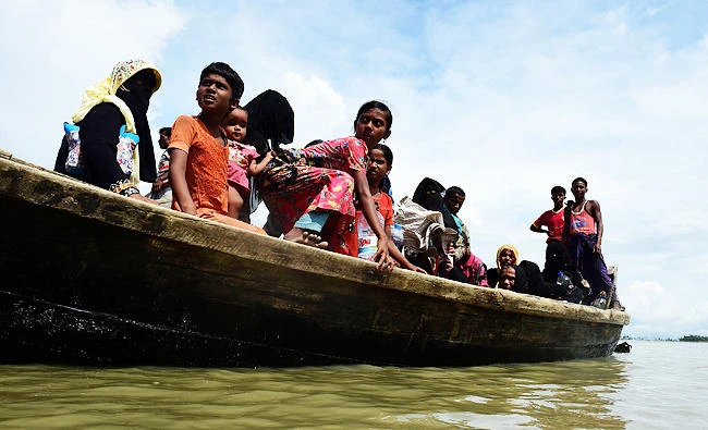 Rohingya Muslim refugees disembark from a boat on the Bangladeshi side of Naf river in Teknaf, in this September 12, 2017 photo. (AFP)