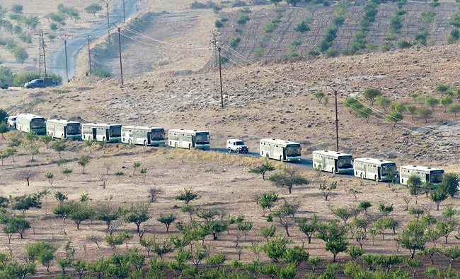 Buses carrying Syrian rebel fighters and their families arrive in Flita, in this August 14, 2017 photo. (AFP)