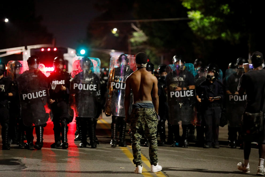 A protester faces off with law enforcement officials following acquittal of former police officer Jason Stockley in St. Louis. (Reuters)
