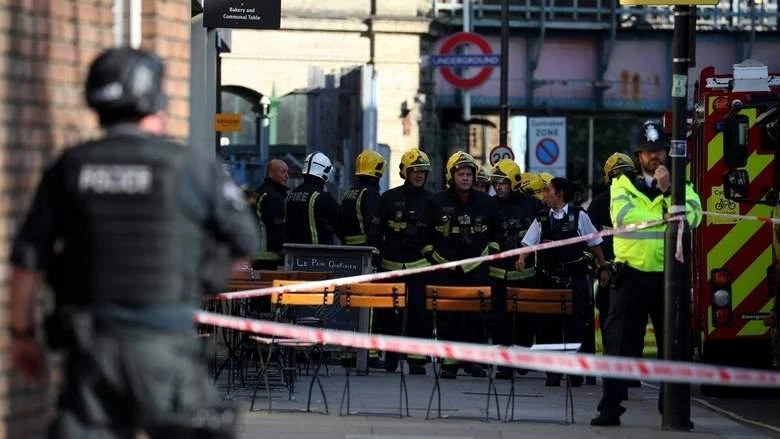 Members of the London Fire Brigade stand by cordon near Parsons Green tube station in London. (Reuters)