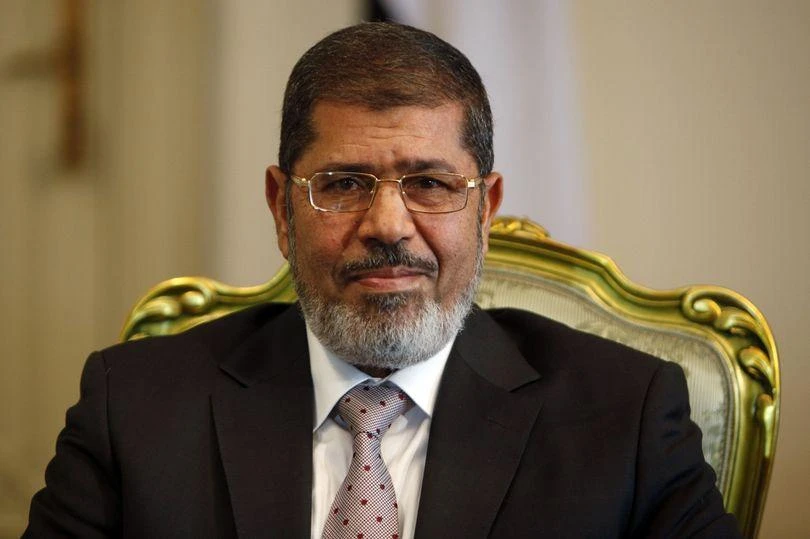Egypt’s ousted President Mohamed Mursi smiles during a meeting with South Korea’s presidential envoy and former Foreign Minister Yu Myung-hwan (not in picture) at the presidential palace in Cairo, on October 8, 2012. (File photo by Reuters)