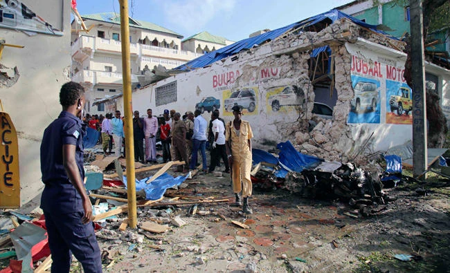 Somali soldiers walk at site of a car bomb attack in Mogadishu on September 11, 2017. (AFP)