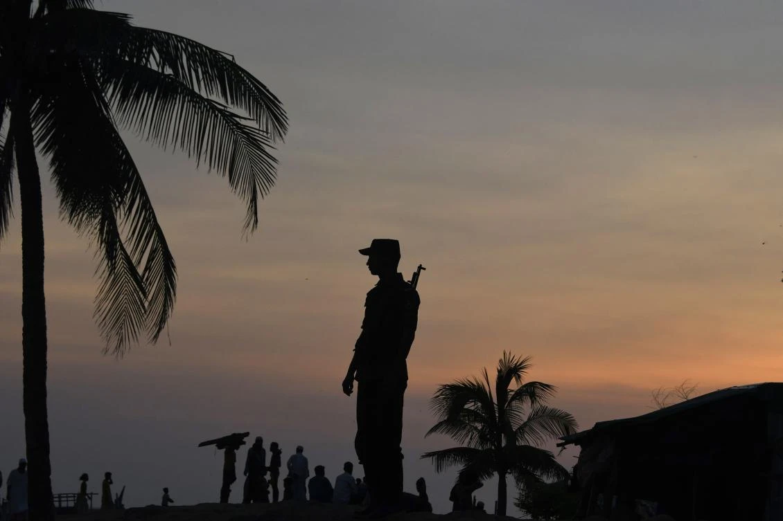A Bangladeshi Border Guard stands guard near the beach of Sharapuri Dwip. (AFP)