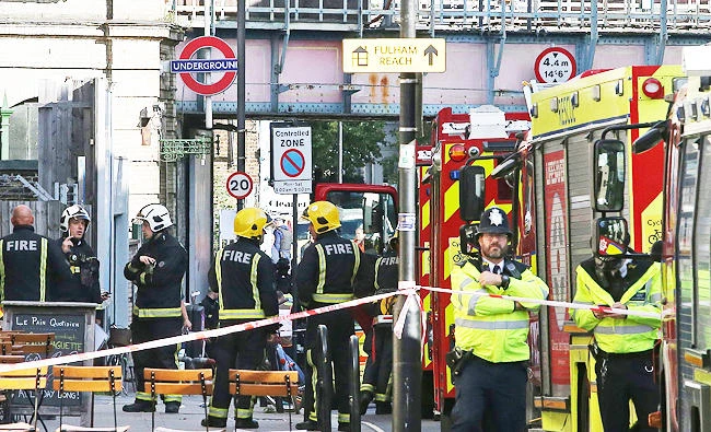 Members of the emergency services work outside Parsons Green underground tube station in west London on Friday, following an incident on an underground tube carriage at the station. (AFP)