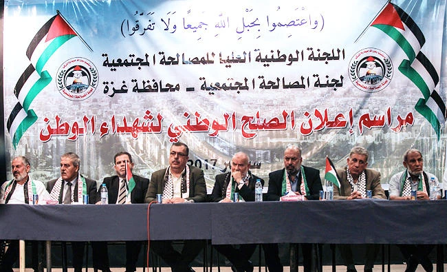 Hamas' MP and head of the parliament in Gaza City Ahmad Bahar (C-R) and Palestinian MP Ashraf Jomaa (R), MP Majed Abu Shamala (C-L) attend a ceremony at which 14 families who lost relatives in fighting between rival Palestinian factions Hamas and Fatah in 2007 are to receive compensation, in Gaza City, in this September 14, 2017 photo. (AFP)