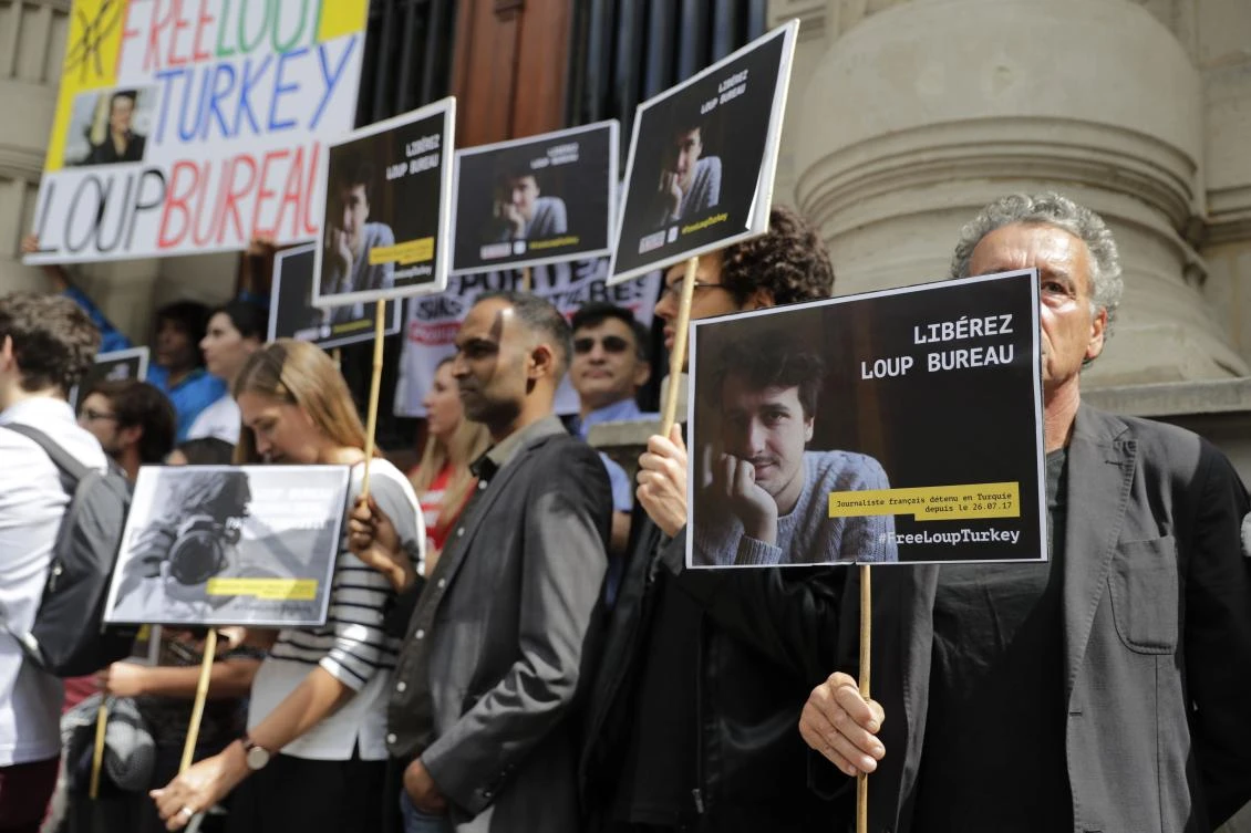 People attend a rally in support of French journalist Loup Bureau, who has been detained in Turkey for the past month, in front of Paris’ 4th district hall in August. (AFP)