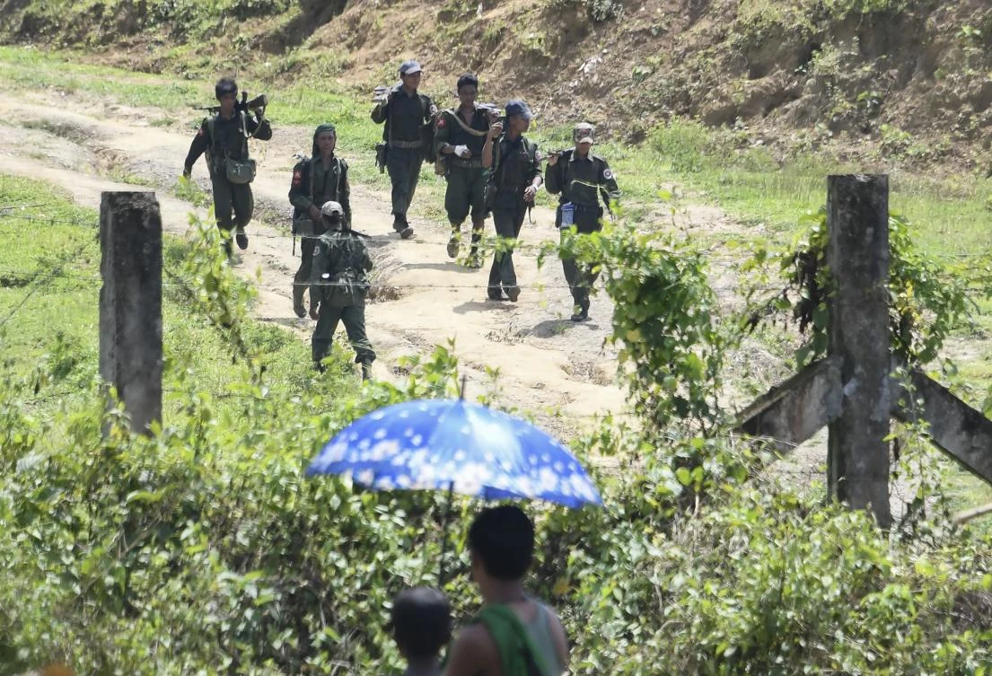 Myanmar soldiers patrol the other side of the no-man’s land area between Myanmar and Bangladesh. AFP