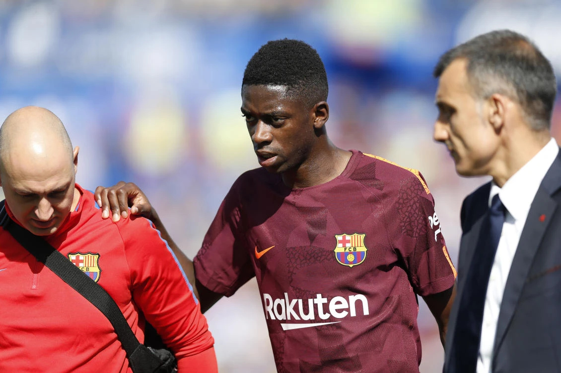Barcelona’s Ousmane Dembele, center, leaves the pitch injured during a Spanish La Liga soccer match between Getafe and Barcelona. (AP)