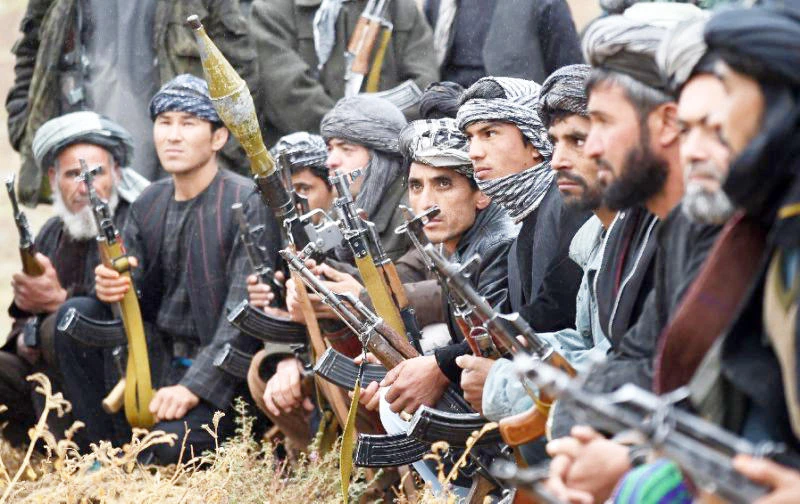 Anti-Taliban Afghan fighters listening to their commander during a patrol against Taliban insurgents at Jamshedi, on the outskirts of northern Faryab province. (AFP)