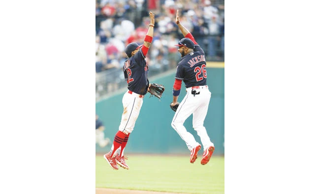 Francisco Lindor (12) and Austin Jackson (26) of the Cleveland Indians celebrate an 8-4 victory over the Kansas City Royals at Progressive Field on Saturday in Cleveland, Ohio. (AFP)