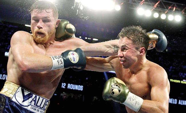 Gennady Golovkin, right, exchanges blows with Canelo Alvarez during their WBC, WBA and IBF middleweight championship fight at the T-Mobile Arena on Saturday in Las Vegas, Nevada. Gennady Golovkin retained his three world middleweight titles, fighting to a draw with Mexican star Canelo Alvarez in a showdown for middleweight supremacy. (AFP)