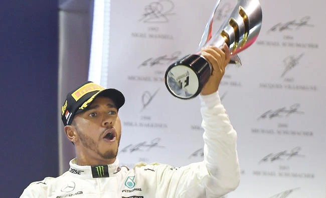 Mercedes’ British driver Lewis Hamilton celebrates after winning the Formula One Singapore Grand Prix in Singapore on Sunday. (AFP)