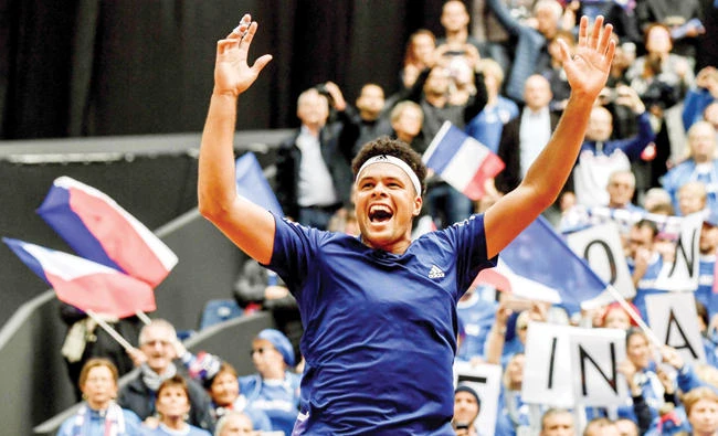 France’s player Jo-Wilfried Tsonga reacts after winning the Davis Cup World Group semifinal tennis match against Serbia at The Pierre Mauroy Stadium in Lille on Sunday. (AFP)