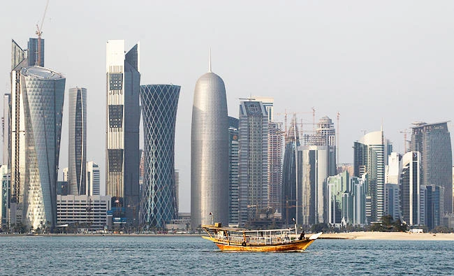 In this Jan. 6, 2011 file photo, a traditional dhow floats in the Corniche Bay of Doha, Qatar, with tall buildings of the financial district in the background. (AP)