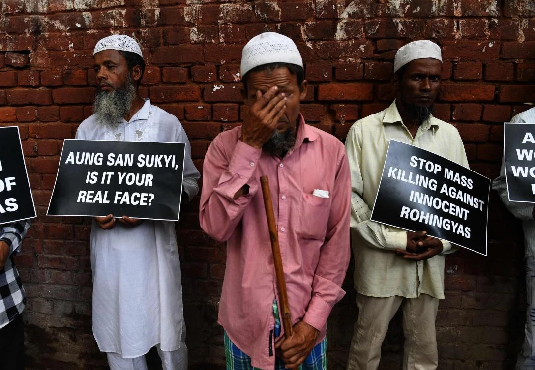 Rohingya Muslim refugees hold placards against human rights violations in Myanmar during a protest in New Delhi. (AFP)