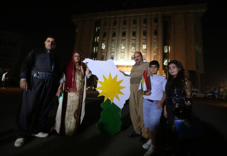 Iraqi Kurds stand outside Kurdistan’s parliament building in Arbil, the capital of the autonomous Kurdish region of northern Iraq on September 15, 2017. (AFP)
