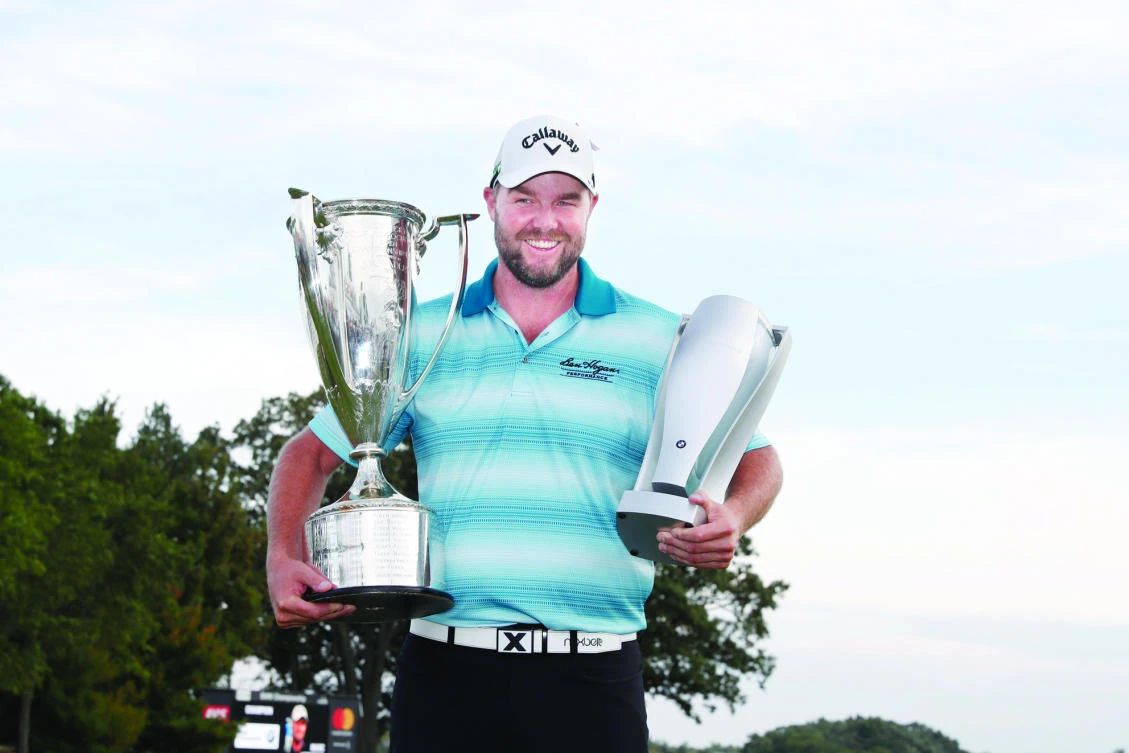 Marc Leishman holds the Wadley Trophy and the BMW Championship Trophy after winning the BMW Championship golf tournament at Conway Farms Golf Club on Sunday. (USA TODAY Sports)