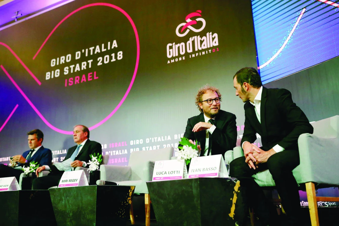 Italy’s Sport Minister Luca Lotti, second right, talks to Italian cycling champion Ivan Basso during a press conference in Jerusalem on Monday to give details of the opening stages of next year's Giro d’Italia. (AFP)