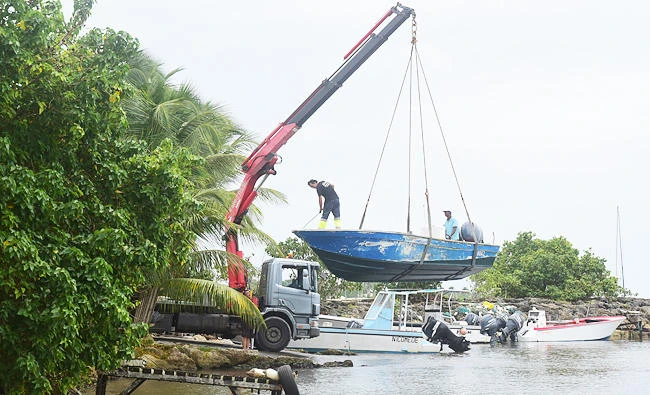 Men remove boats from the water ahead of Hurricane Maria in the Galbas area of Sainte-Anne on the French Caribbean island of Guadeloupe, early Monday. (AP)