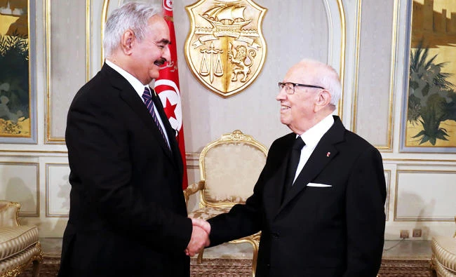 A handout photo released by the Tunisian Presidency Press Service shows Tunisian President Beji Caid Essebsi (R) meeting with Libyan General Khalifa Haftar on Monday at Carthage Palace in Tunis. (AFP)