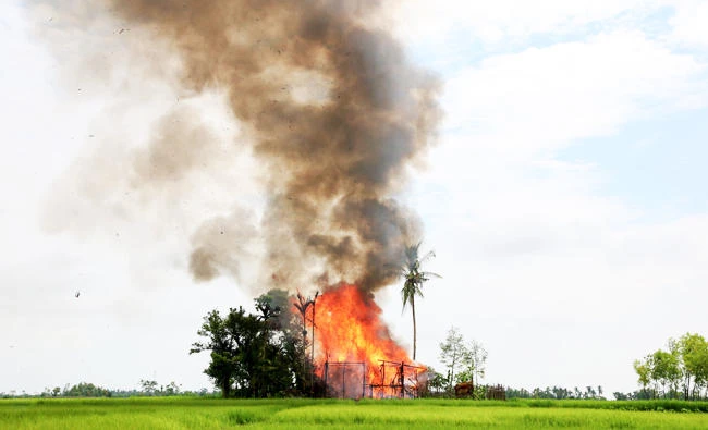 In this photo taken on September 7, 2017, a house burns in Gawdu Tharya village near Maungdaw in Rakhine state in northern Myanmar. (AFP)