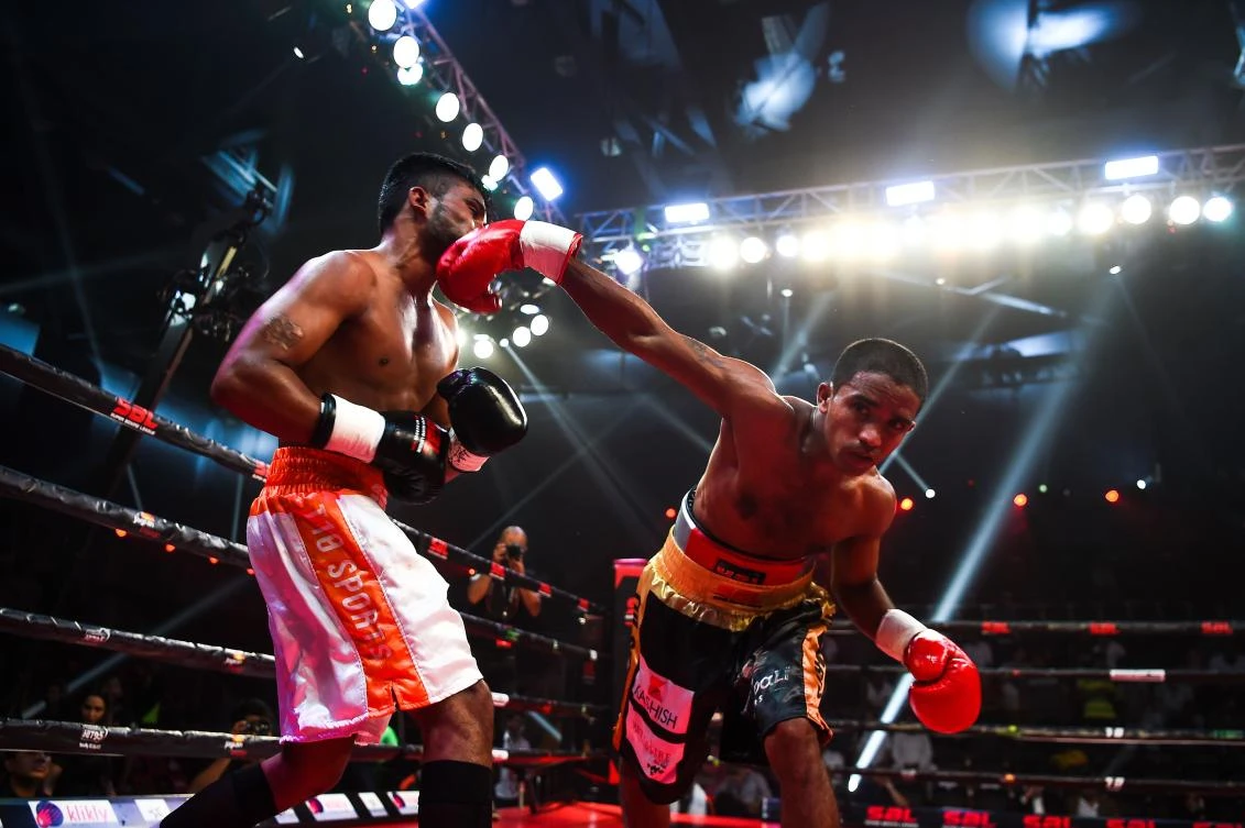 Indian boxer Venkat Naik (R) with the Bahubali Boxers punches Maratha Yoddhas' Sandeep Singh during a Super Boxing League event in New Delhi. (AFP)
