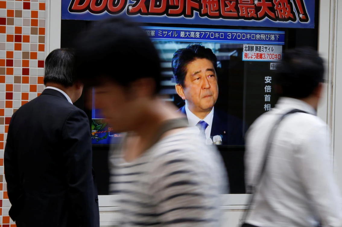 Passersby look at a TV screen reporting news on Japan's Prime Minister Shinzo Abe speaks to media about North Korea's missile launch in Tokyo, Japan. (Reuters)