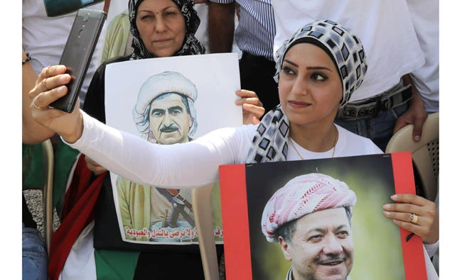 A Lebanese Kurd takes a selfie with a portrait of Massoud Barzani, Kurdish regional president, during a recent demonstration in Beirut in support of the referendum vote on Kurdish independence planned for Sept. 25 in the Kurdish region of Iraq. (AFP)
