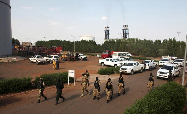 In this file photo, Sudan People's Liberation Army (SPLA) soldiers walk past the Paloch oil field facility in Paloch, Upper Nile State, South Sudan on March 2, 2014. (Reuters)