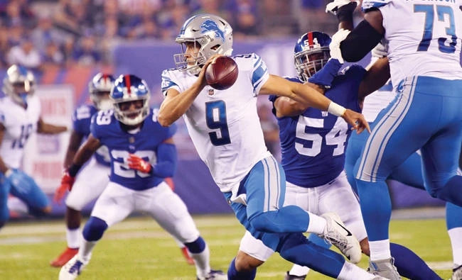 Detroit Lions quarterback Matthew Stafford (9) runs with the ball against the New York Giants during a NFL football game at MetLife Stadium on Monday. (USA TODAY Sports)