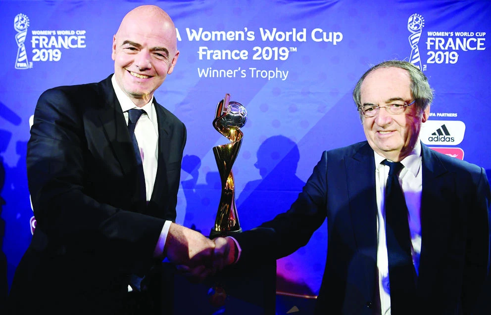 FIFA President Gianni Infantino, left, and the president of French Football Association (FFF) Noel Le Graet, shake hands in front of the trophy after the official start of the organization of the 2019 FIFA Women World Cup in France on Tuesday in Paris. (AFP)