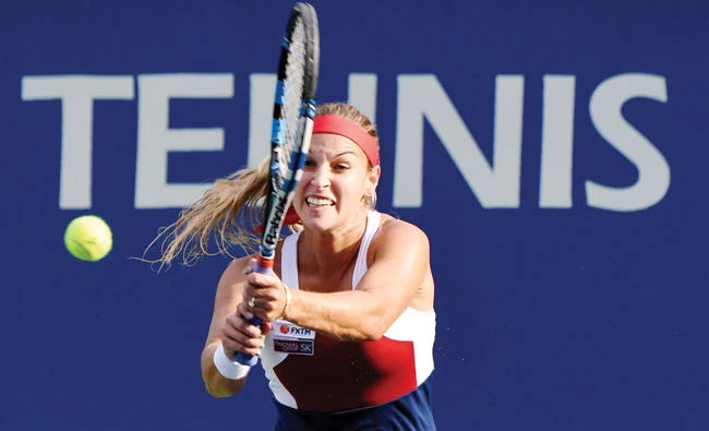 Dominika Cibulkova of Slovakia hits a return against Carla Suarez Navarro of Spain during their women's singles first round match at the Pan Pacific Open tennis tournament in Tokyo on Tuesday. (AFP)
