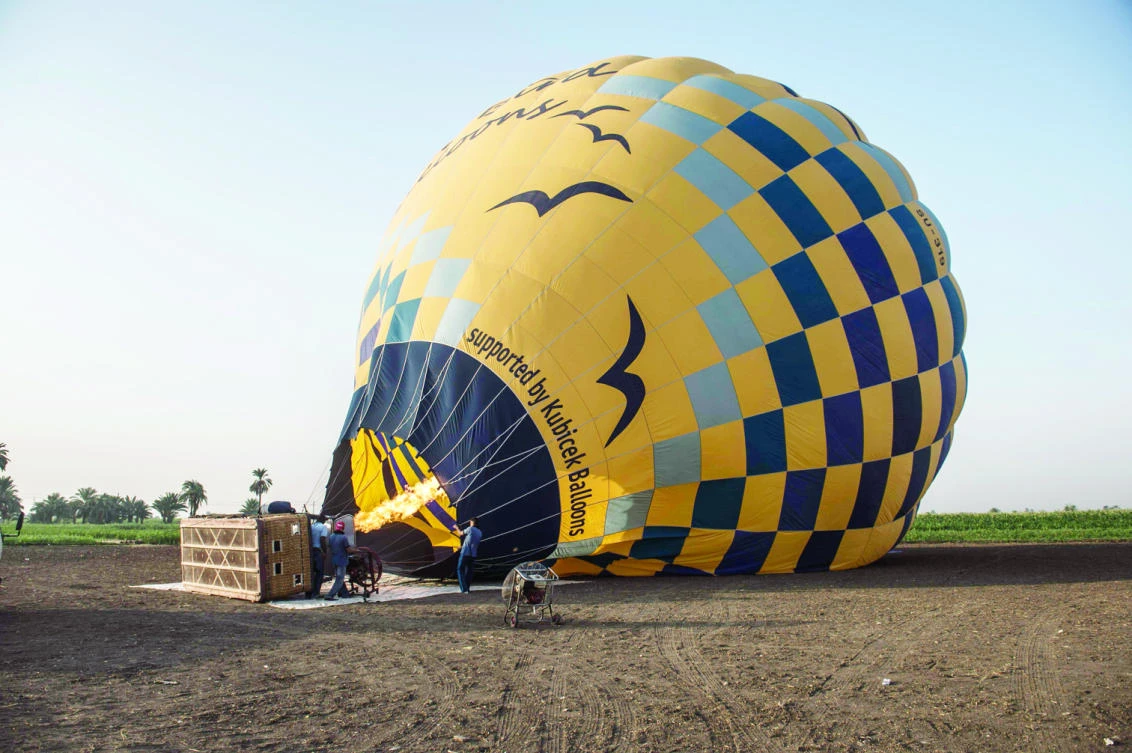 Egyptian workers prepare a hot air balloon for a ride over the ancient city of Luxor, a city that has been hit by a tourism drought. (AFP)