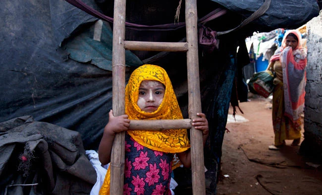 A Rohingya Muslim girl Yasmin Ara stands in front of her shanty at a camp for refugees in Hyderabad, in this Sept. 18, 2017 photo. (AP)
