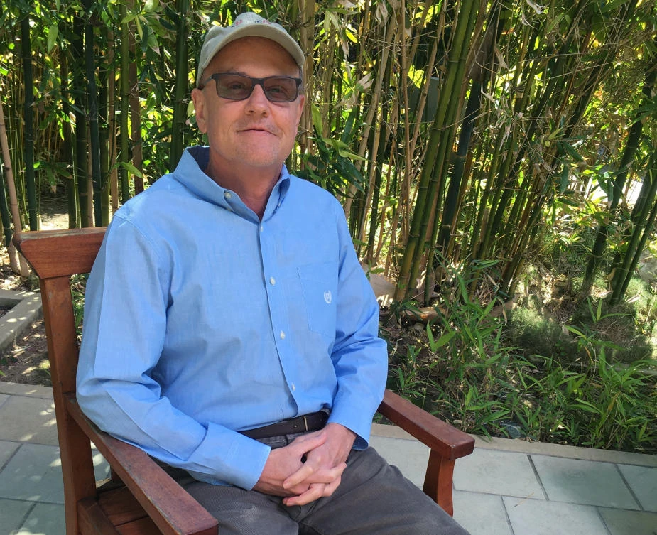 Dennis Lyon sits outside the University of California, San Diego's Moores Cancer Center, where he was treated for an unusual skin cancer that had spread widely. (AP)