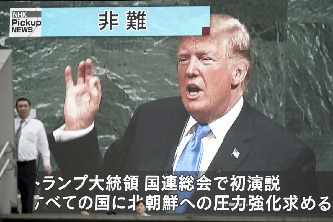 A man walks past a TV screen showing US President Donald Trump speaks at the UN General Assembly, in Tokyo. (AP)