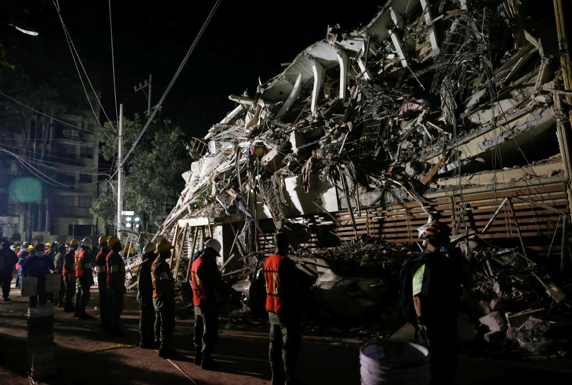 Rescuers work at the site of a collapsed building after an earthquake in Mexico City, Mexico, on September 20, 2017. (REUTERS)