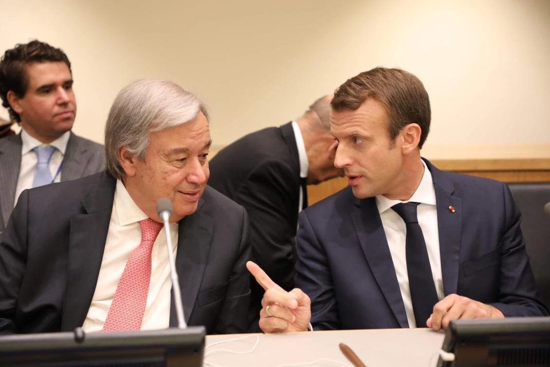 French President Emmanuel Macron (R) speaks with Antonio Guterres, Secretary-General of the United Nations. (AFP)