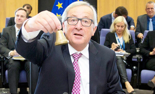 European Commission (EC) President Jean-Claude Juncker rings a bell to signal the beginning of a meeting of the college of commissioners at EU headquarters in Brussels. A draft law, presented by EC vice president Valdis Dombrovskis, is intended to toughen EU financial rules. (AP)