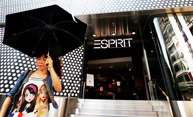 A woman walks outside the biggest Esprit store in Hong Kong. The retailer reported a more-than-threefold rise in full-year profit. (Reuters)