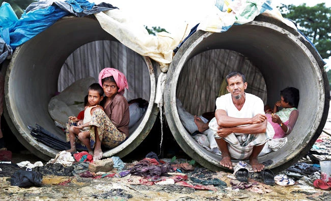 Rohingya refugees living in concrete pipes in Cox's Bazar, Bangladesh, on Wednesday. (REUTERS)