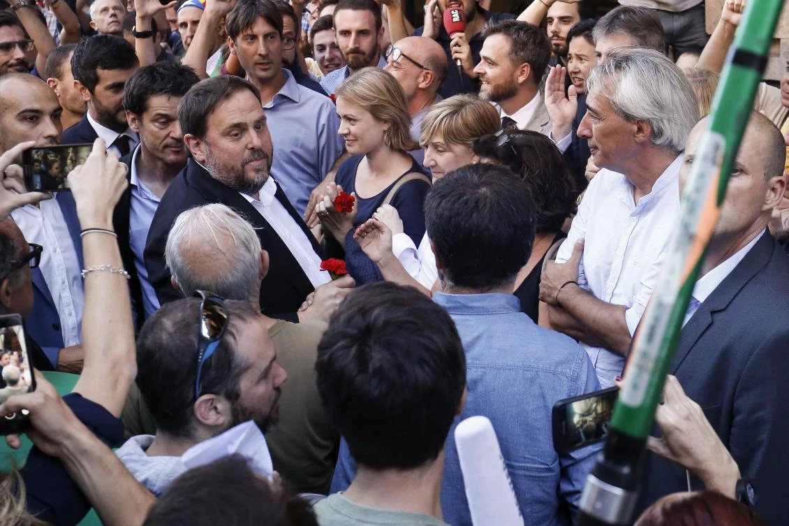 Oriol Junqueras, deputy head and economy minister of the regional government, left, arrives at the Economy headquarters of Catalonia’s regional government. Junqueras said plans to hold an independence referendum on October 1 were now in doubt. (AFP)